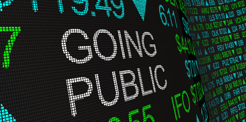 Digital text on a screen displaying stock prices and the words 'GOING PUBLIC'.