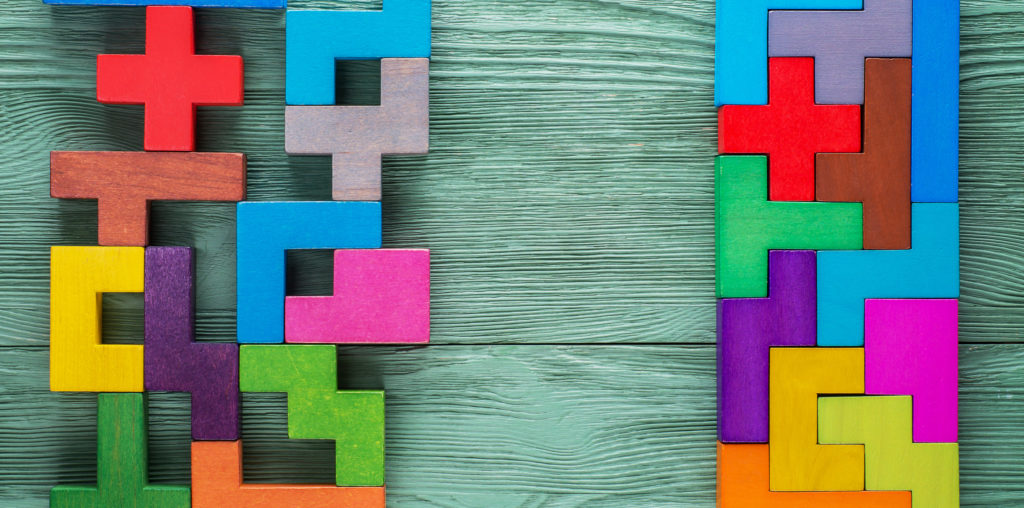 Colourful wooden shapes displaying the concept of entity rationalisation.