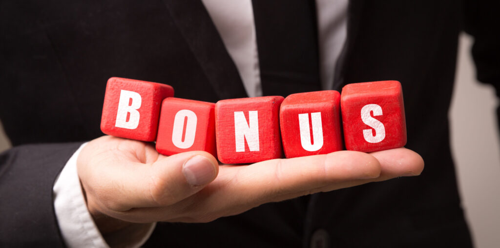 Businessman holding 5 red cubes spelling the word 'BONUS' on the palm of his hand.